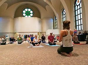 MSU Denver staff and students do yoga in St. Cajetans.